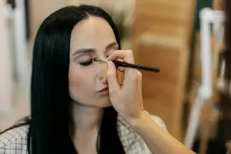 Close-up of a makeup artist doing eye makeup